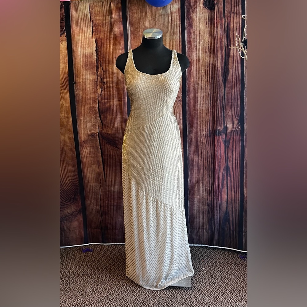 Fully beaded cream maxi dress with a leg slit on the right.